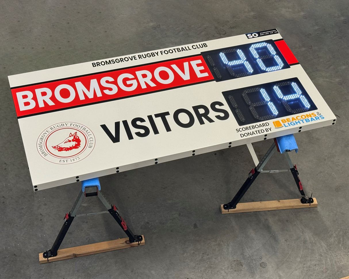 Electronic Scoreboard for Bromsgrove Rugby Football Club with led digital display on a gray surface.