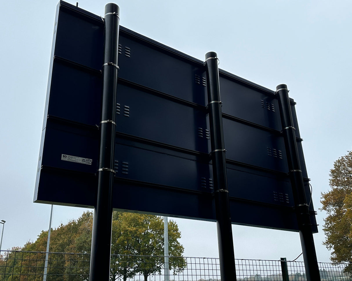 fitting an electronic scoreboard onto posts using sign rails and sign clips.