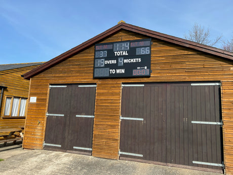 23 Digit LED Cricket Scoreboard mounted on a shed. High-intensity LED digits