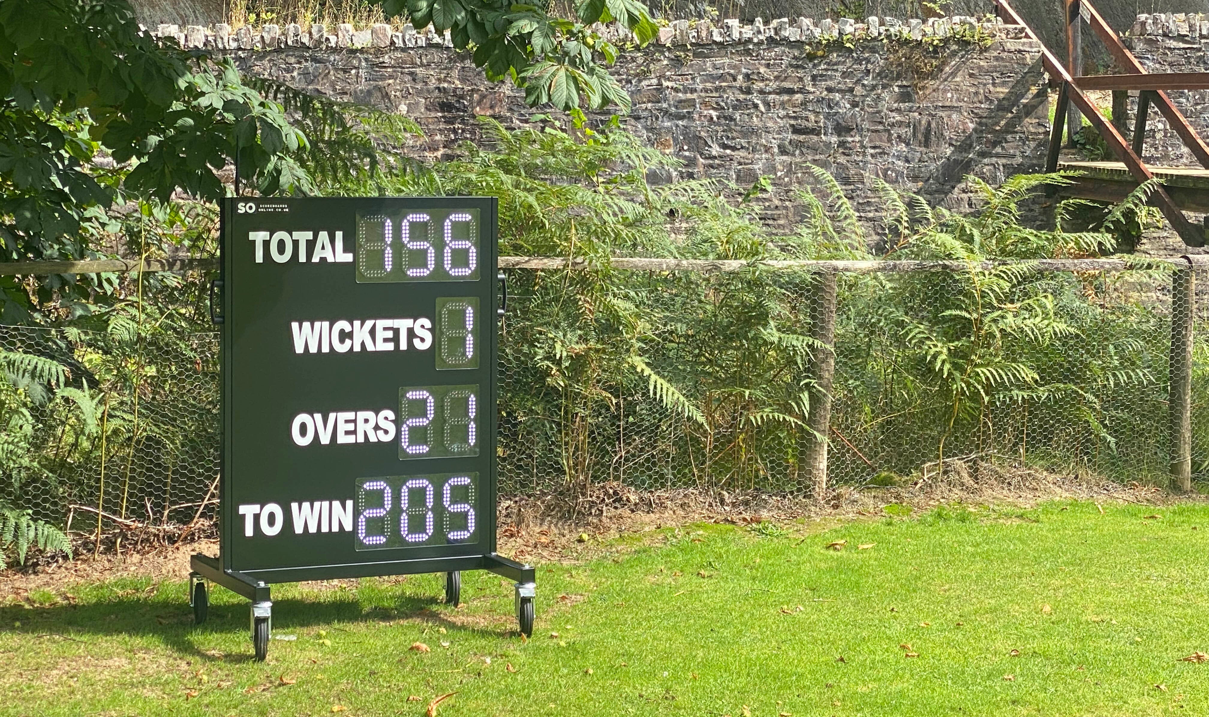 9 digit cricket scoreboard at Bridgetown Cricket Club. On a mobile trolley with Total, Wickets, Overs and a To Win